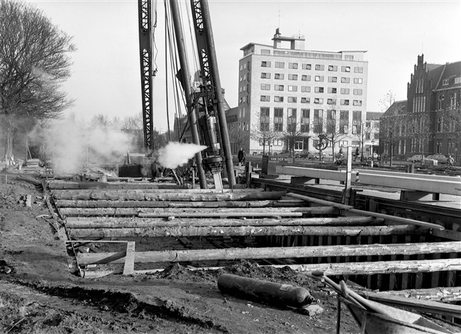 Een paal wordt in de grond geslagen bij de bouw van de eerste St. Sebastiaansbrug.