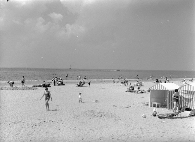 Zomerse drukte met dagjesmensen op het strand. De provincie Zuid-Holland maakt stranden beter bereikbaar door het aanleggen of verbeteren van wegen ernaartoe.