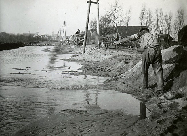 Het aanplempen, oftewel dempen van een sloot, waarschijnlijk bij Groot-Ammers. Deze foto is waarschijnlijk gemaakt tussen 1930 en 1939.