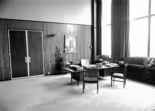 De werkkamer van de commissaris van de Koningin, in het provinciehuis aan de Zuid-Hollandlaan. Meubelfabriek H.P. Mutters uit Den Haag heeft het interieur verzorgd, waaronder de wandbetimmering, het houten plafond en de houten deuren.