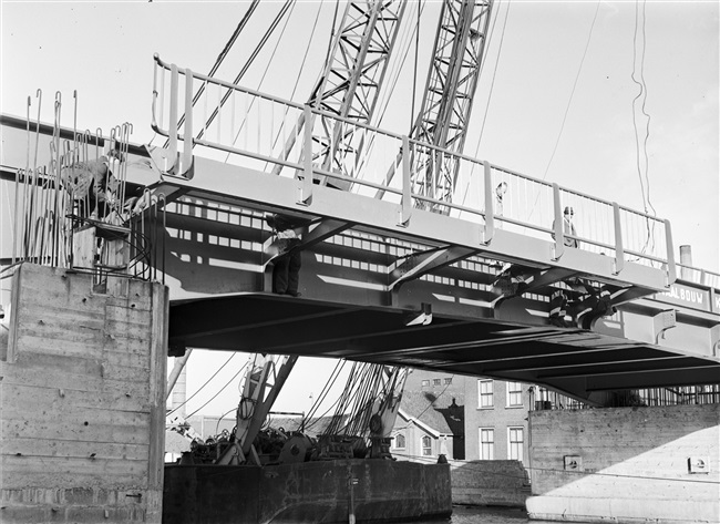 Een drijvende bok plaatst het hekwerk van de 's-Molenaarsbrug.